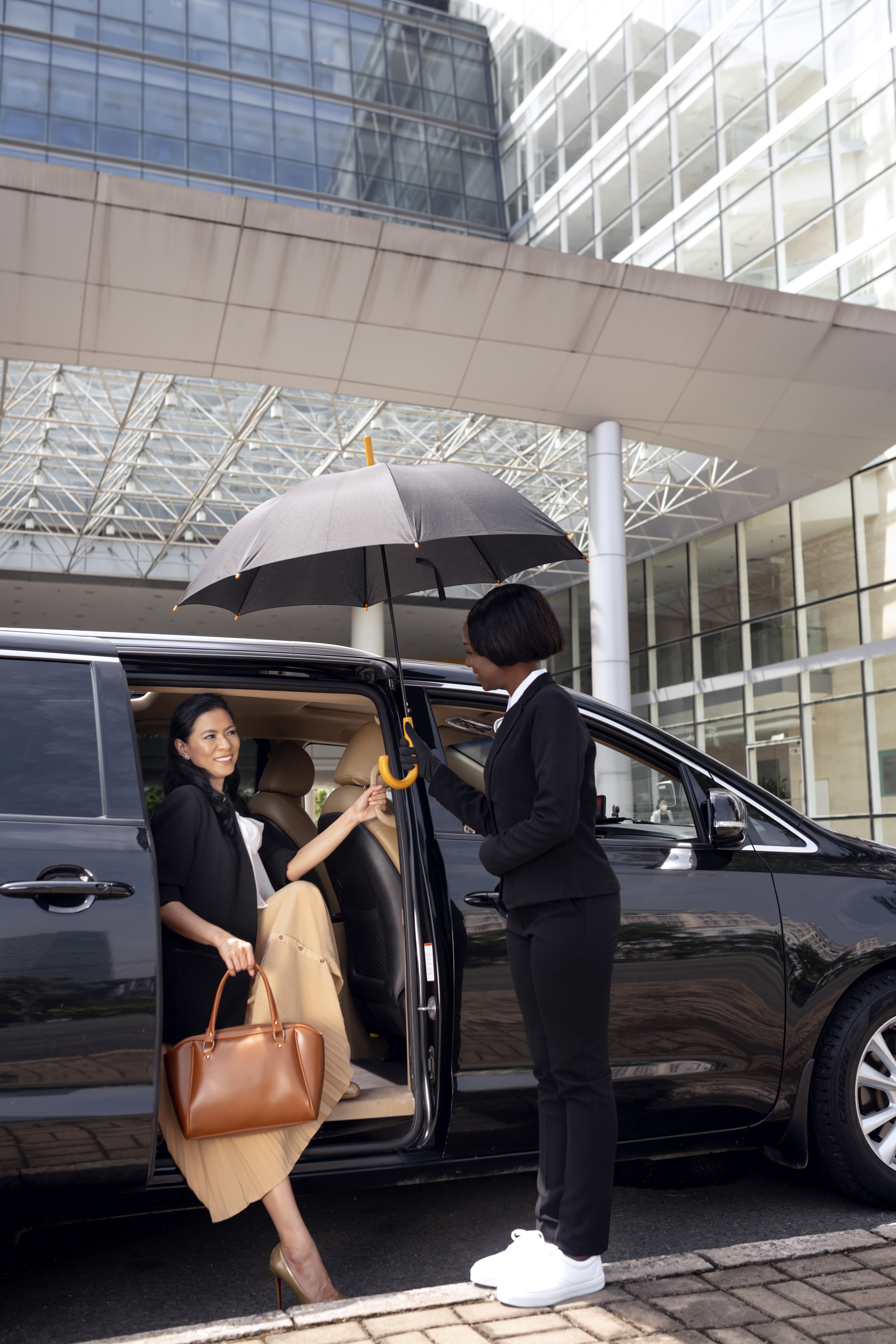 Private airport transfer passenger entering chauffeur vehicle in Toronto